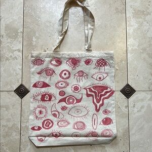 Stylish Cream Tote Bag with Red Eye Design